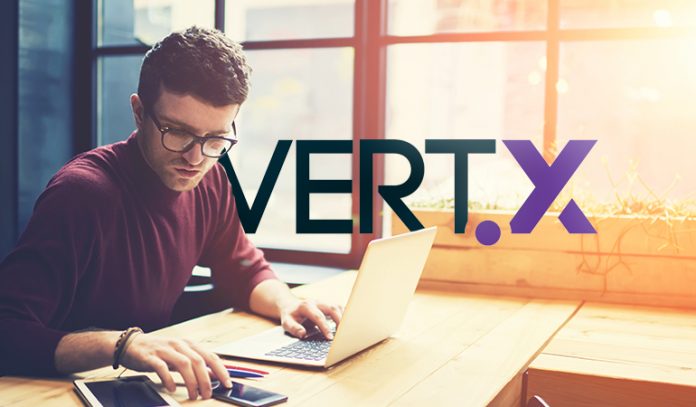 vertx person at computer with Vertx logo