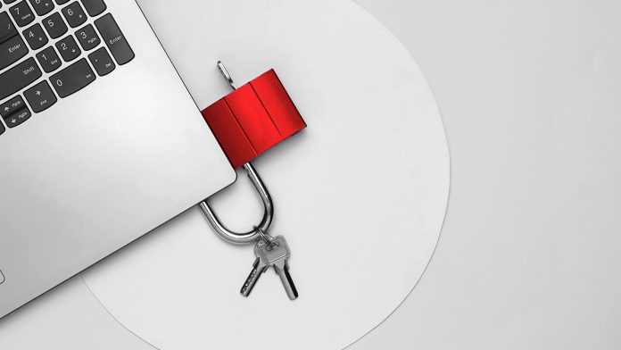 The concept of cyber defense, online security. Laptop and padlock on a white background with blue circle. Top view. Minimalism